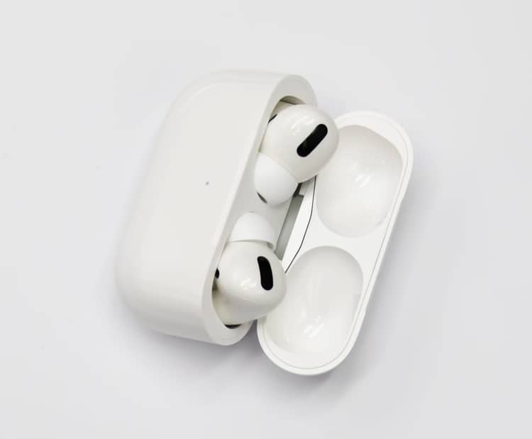 Open AirPods Pro charging case with silicone-tip earbuds seated in the tray