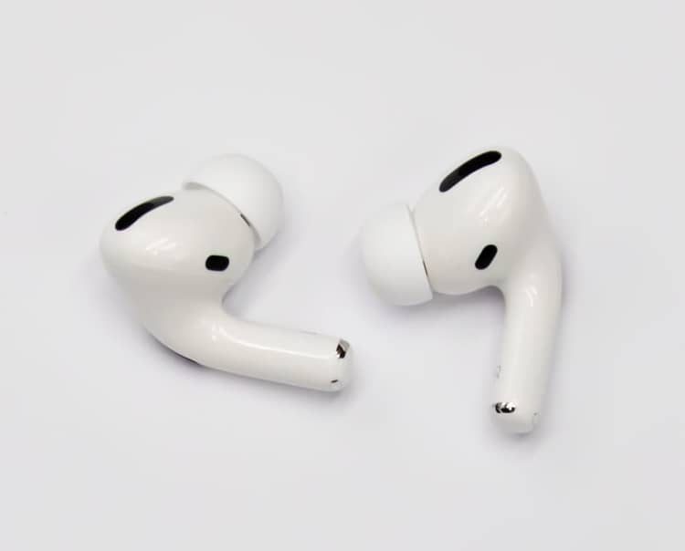 Two AirPods Pro earbuds showing short stems, silicone tips, and stem vents